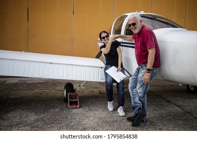 The Older Couple Prepares To Fly In A Smaller Airport With Good Fun And Laughter