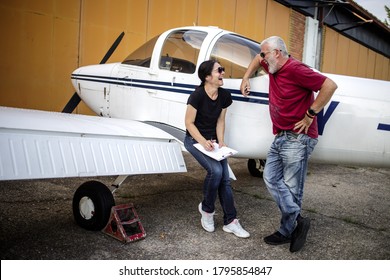 The Older Couple Prepares To Fly In A Smaller Airport With Good Fun And Laughter