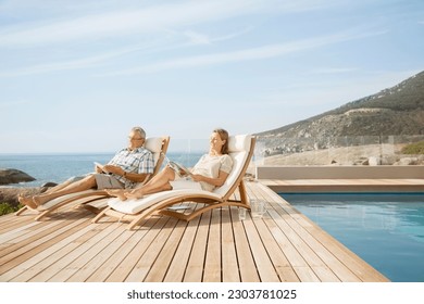 Older couple relaxing by pool - Powered by Shutterstock