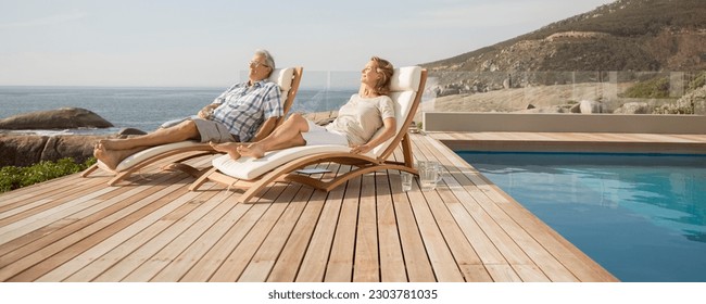 Older couple relaxing in lawn chairs by pool - Powered by Shutterstock