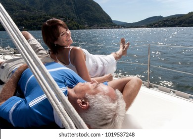 Older Couple Relaxing On Sailboat