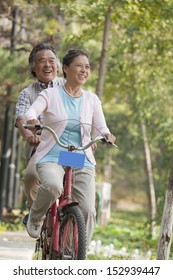 Older Couple Riding Tandem Bicycle, Beijing