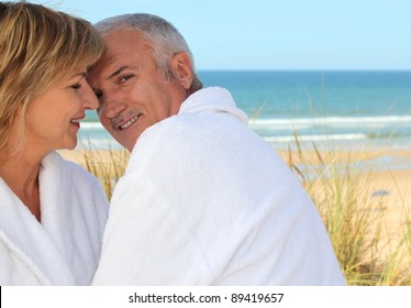 Older Couple Smooching In The Sand Dunes