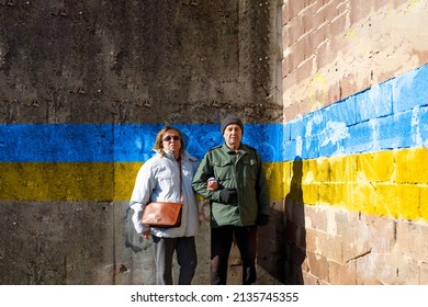 Older Couple Standing In Front Of A Old Wall