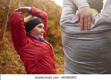 Older Couple Stretching Their Arms And Hands