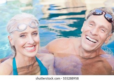 Older Couple Swimming In Pool