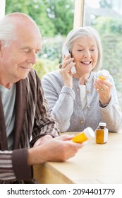 Older Couple Taking Medication At Home