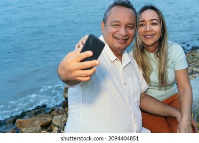 Older Couple Taking A Selfie With Their Mobile