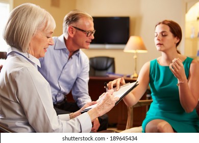 Older Couple Talking To Financial Advisor In Office