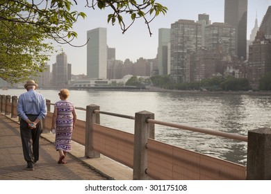 Older Couple Walking Along Park Path