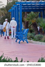 Older Couple Walking Along The Promenade Of Malaga