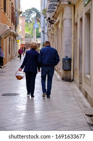 Older Couple Walking Away On Their Way To Easter Mass In Zadar, Croatia, April 21, 2019