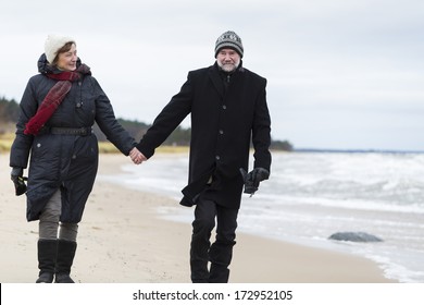 Older Couple Walking The Beach