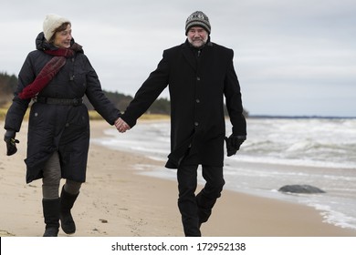 Older Couple Walking The Beach