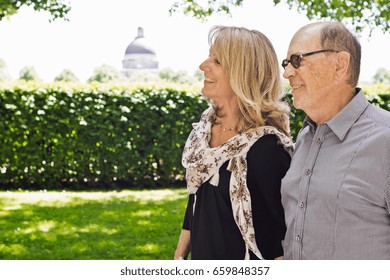 Older Couple Walking Hand-in-hand