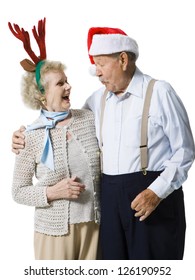 Older Couple Wearing Christmas Hats Laughing