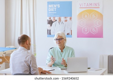 Older Dietician Talking To Male Patient About His Diet