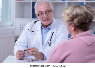 Older Doctor Prescribing To Aged Female Patient Medicines