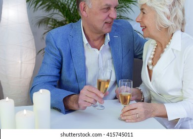 Older Elegant Couple Drinking Champagne During Wedding Anniversary Celebration