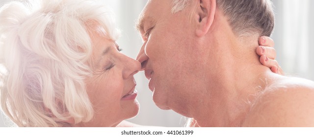 Older And Experienced Couple Tenderly Prepares To Kiss 