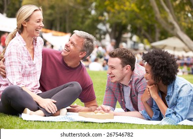 Older Family Relaxing At Outdoor Summer Event