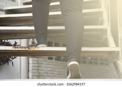 Older and fatter women walk up and down the stairs to exercise at home. For good health of their own in the evening everyday