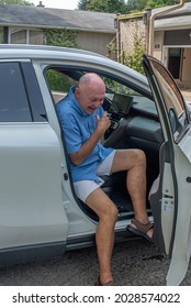 A Older Gay Man Wearing Shorts, Gets Out Of The Passenger Seat Of A Car.