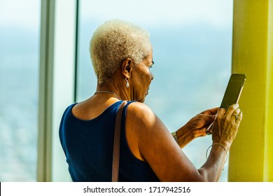 OLDER GENERATION, FEMALE, USING TECHNOLOGY-21st DECEMBER 2019:-Older generation black women utilising modern technology