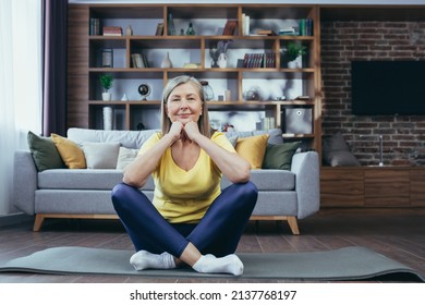 Older Gray-haired Woman At Home Alone, Active Lifestyle, Yoga, Lotus Position And Meditating