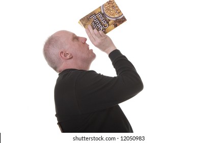 An Older Guy In A Black Shirt Eating Granola From A Box