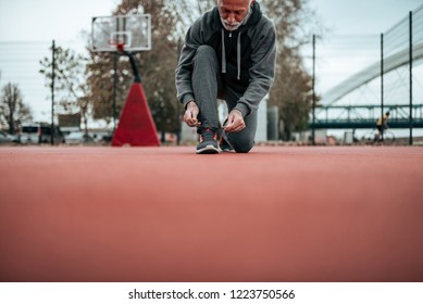 Older Guy Getting Ready To Play Some Basketball.