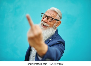 Older Hipster Man In Positive Attitude With Angry Facial Expression Shows Fuck You. - Focus On The Face