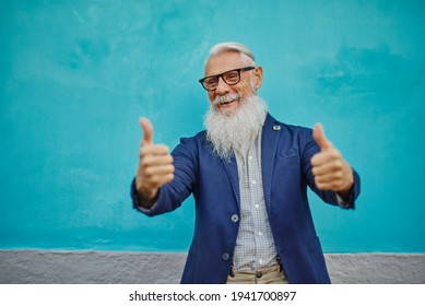 Older Hipster Man In Positive Attitude With Happy Facial Expression Shows Fuck You. - Focus On The Face