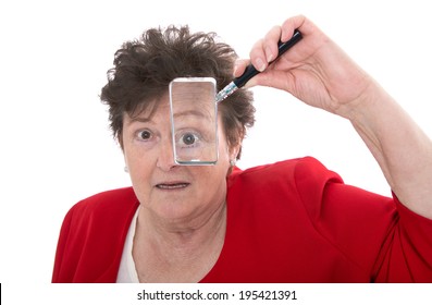 Older Isolated Woman Holding Magnifying Glass And Is Shocked.