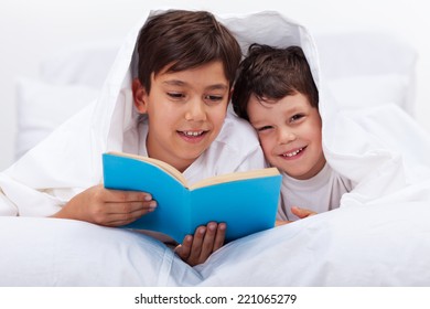 Older Kid Reading To His Little Brother - Laying In Bed