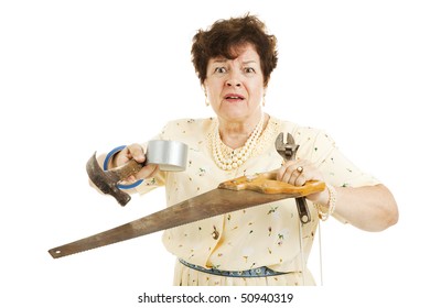 Older Lady Holding Tools.  She Is Confused And Overwhelmed By Home Improvement Project.  Isolated On White.