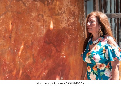 Older Latina Woman With Long Hair In The Street