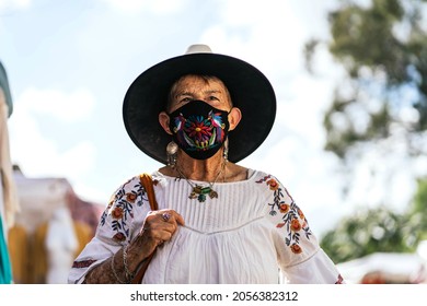 Older Latina Woman With Mask Thinking 