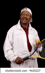 Older Male African American Tennis Player In White Sports Outfit Over Black Background