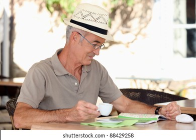 Older Man At An Alfresco Cafe