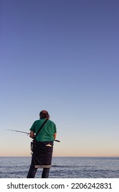 Older Man From Behind Fishing On The Sea Coast