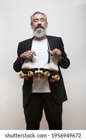 
Older Man With Blazer And Roller Skates Around His Neck