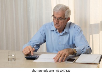 Older Man Doing His Taxes At Home