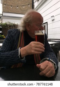 Older Man Drinking Beer In An English Pub