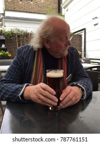 Older Man Drinking Beer In An English Pub