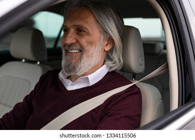 Older Man Driving His Car And Smiling