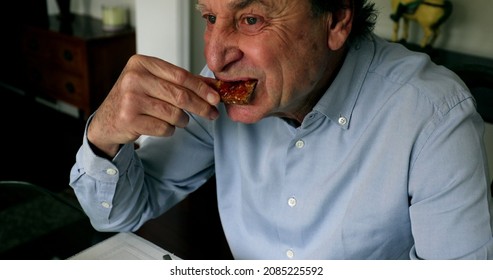 Older Man Eating Toast Bread With Jelly In Breakfast Morning