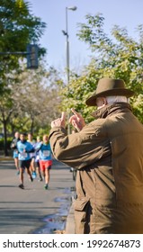 Older Man Encourages Marathon Runners