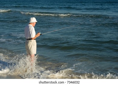 An Older Man Fishing At The Beach.