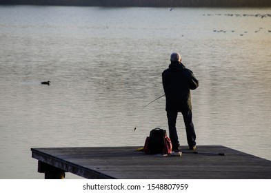 Older Man Fishing On A Pier